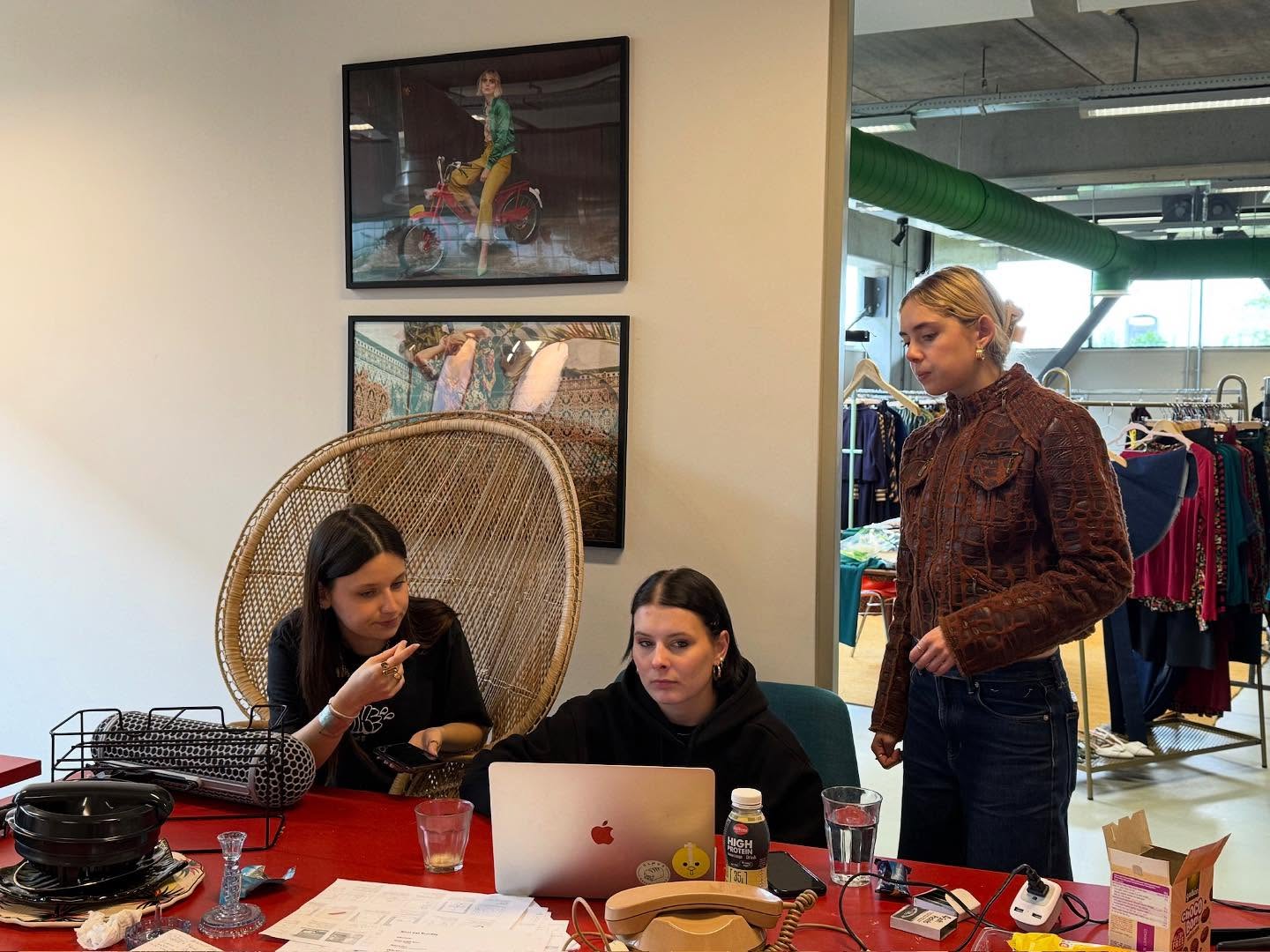 Behind the scenes: the crew planning the shoot around a laptop