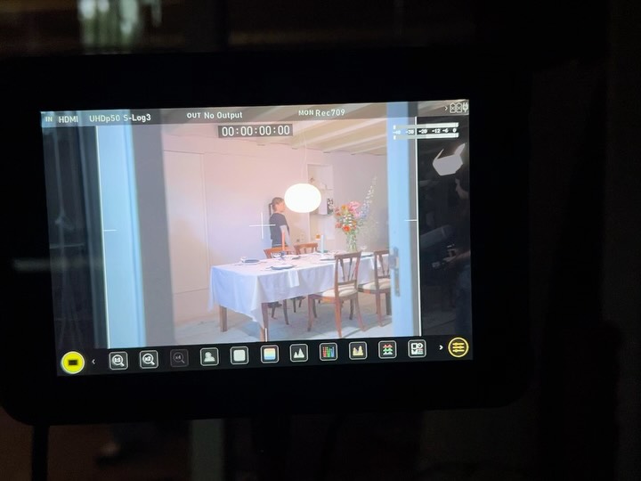 Behind the scenes: the dining room set framed up on the camera monitor